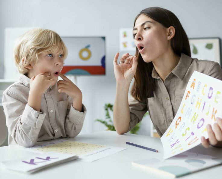 woman-doing-speech-therapy-with-little-blonde-boy